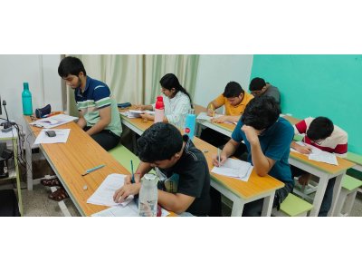 Students concentrating on an academic assessment at classroom desks