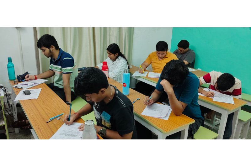 JEENEET Academy students completing written practice papers in the classroom