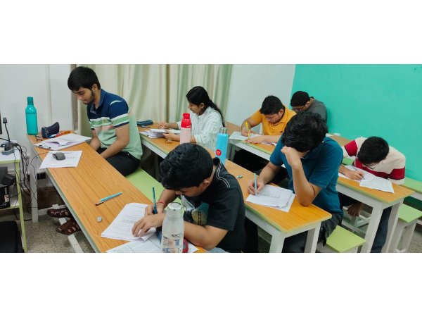 Students concentrating on an academic assessment at classroom desks